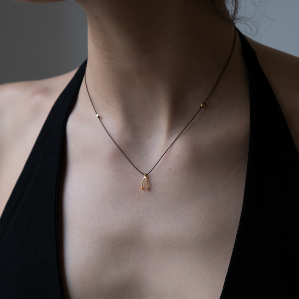 14k gold Wishbone Charm necklace on silk