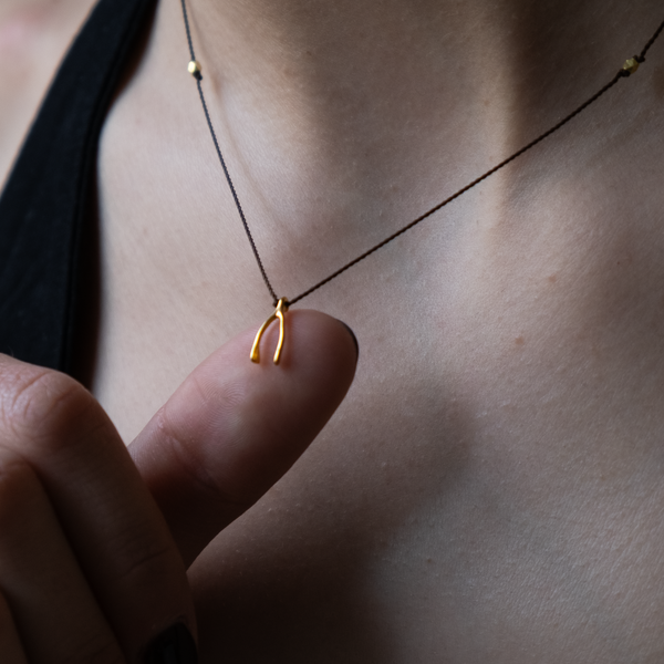 14k gold Wishbone Charm necklace on silk